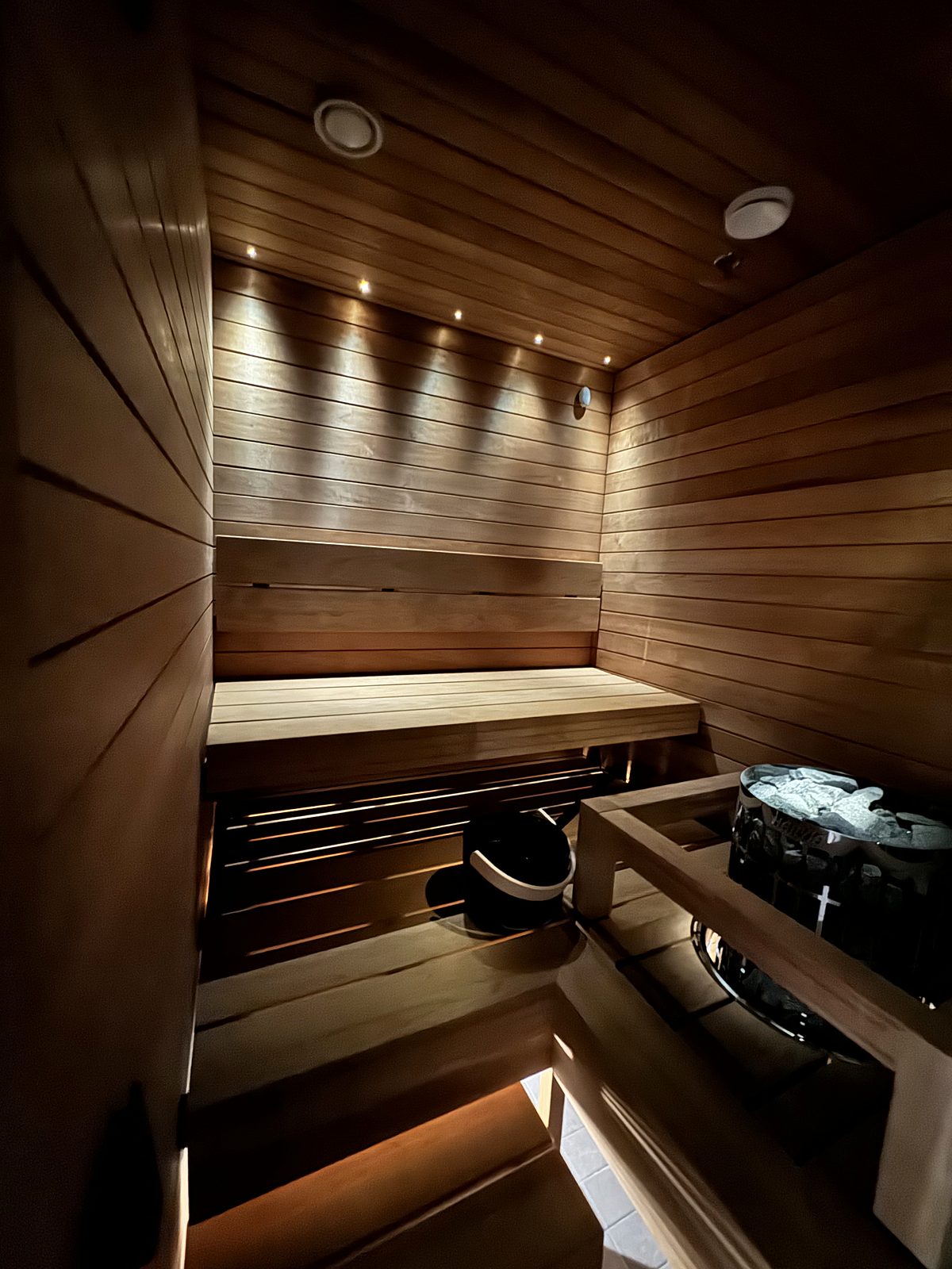 The sauna, with wooden benches and the heater