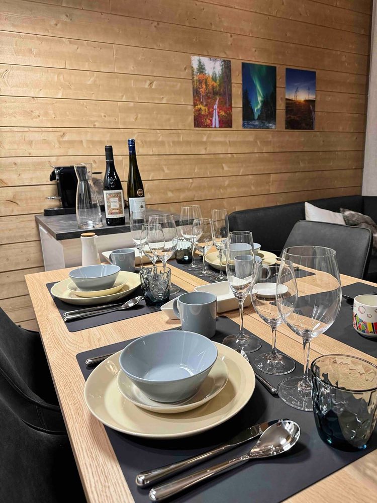 The dining table laid with plates, bowls and wine glasses