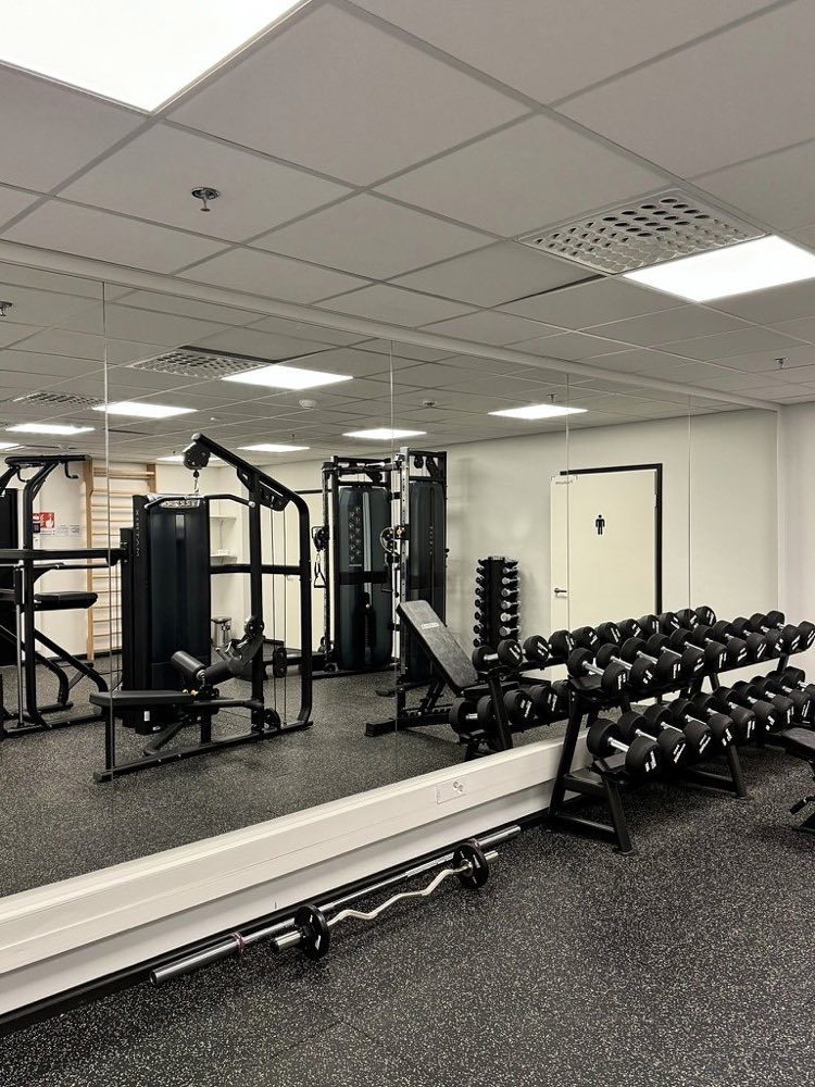 Dumbbells on racks in the building's gym
